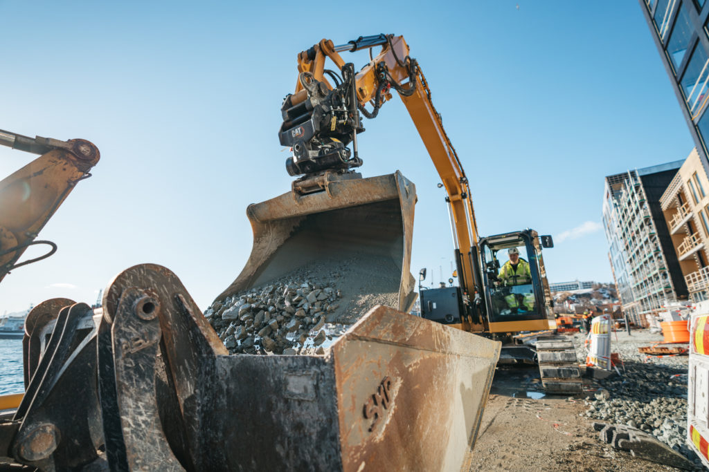 a construction vehicle loading rocks into a bucket