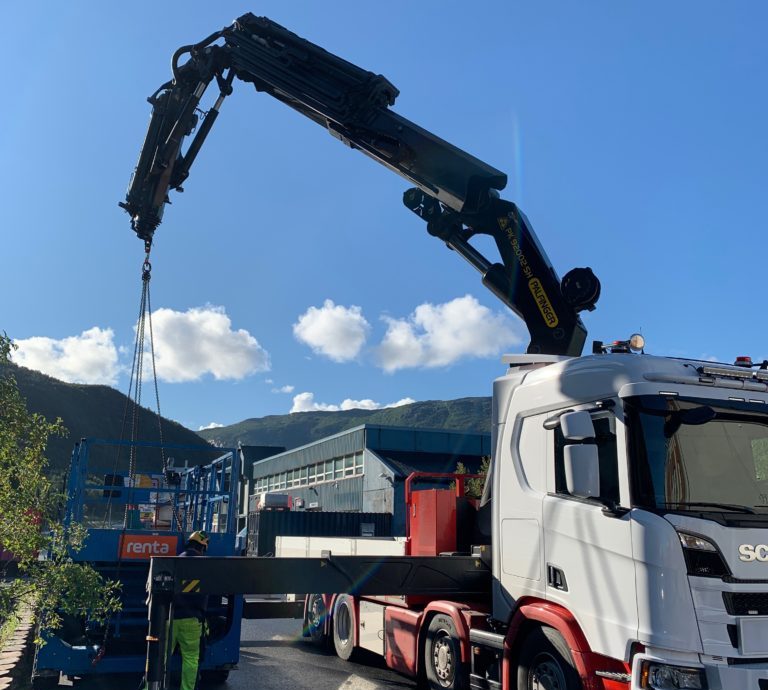 a crane lifting a truck