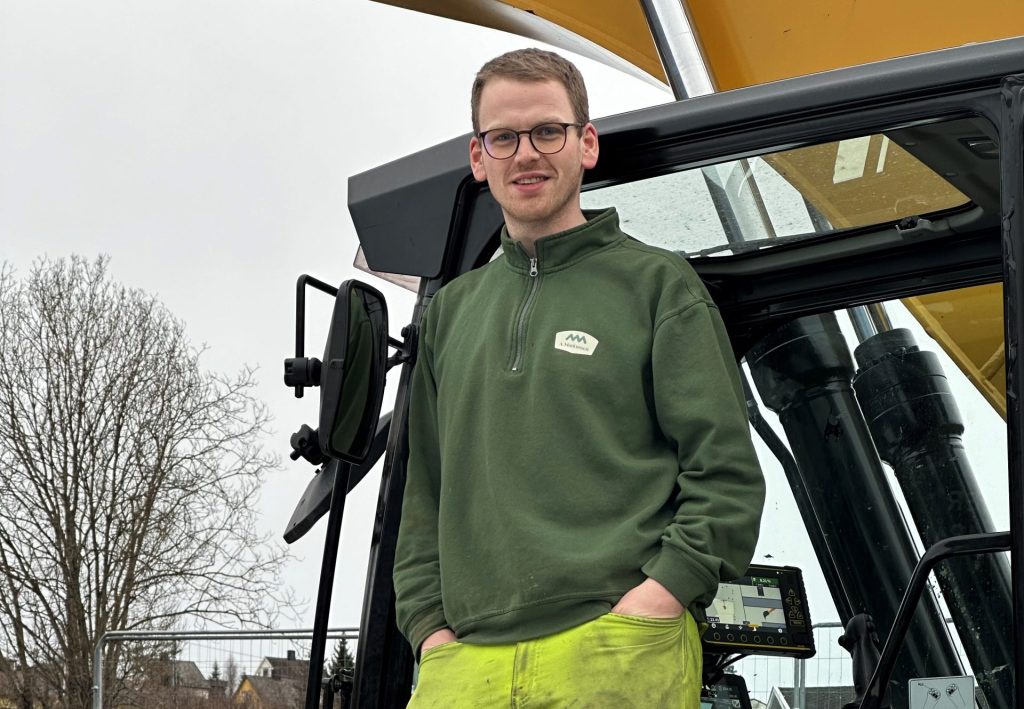 a man standing in front of a tractor